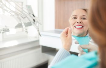 Dental Implant Patient Looking in Mirror