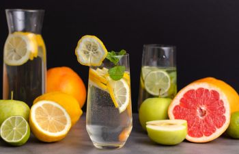 Glasses of water with slices of fruit.